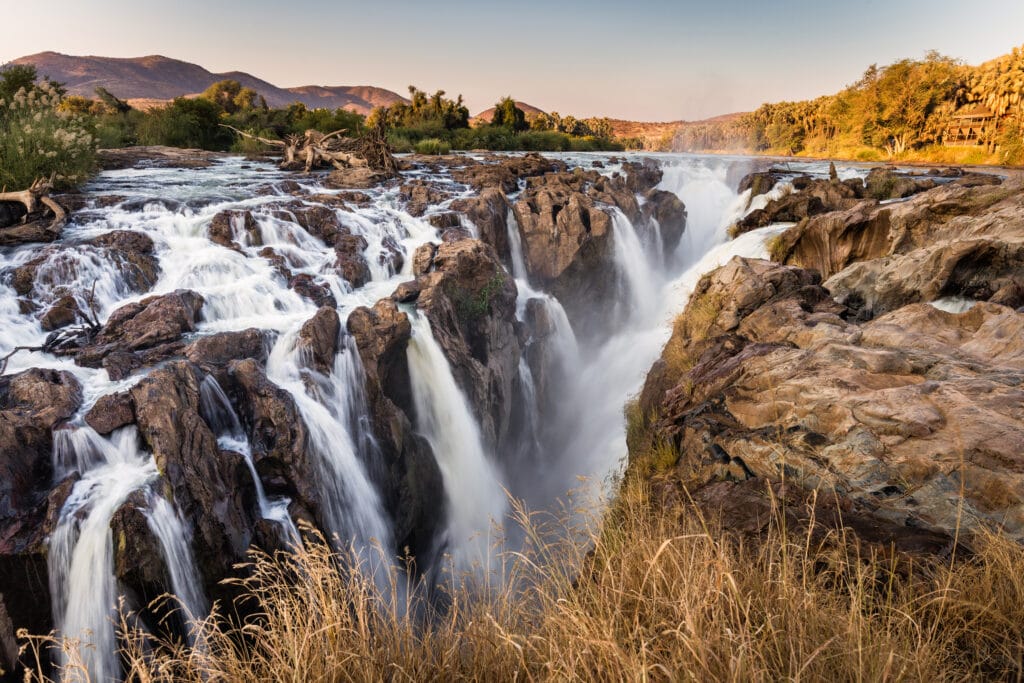 Epupa falls,  Kaokoveld, Namibia, in warm evening light, water movement frozen by moderate shutter speed