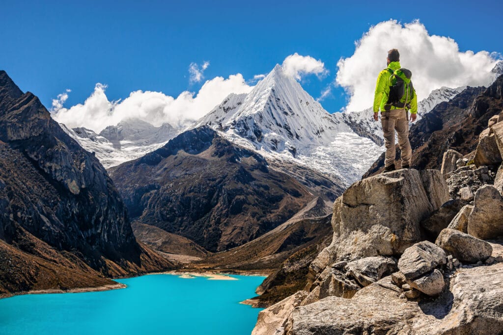 Male Adventurer Looks at the Landscape of Peruvian Mountains in Cordillera Blanca, During Santa Cruz Trekking, Ancash Region, near Huaraz, Adventurous and Touristic Destination in Peru, South America